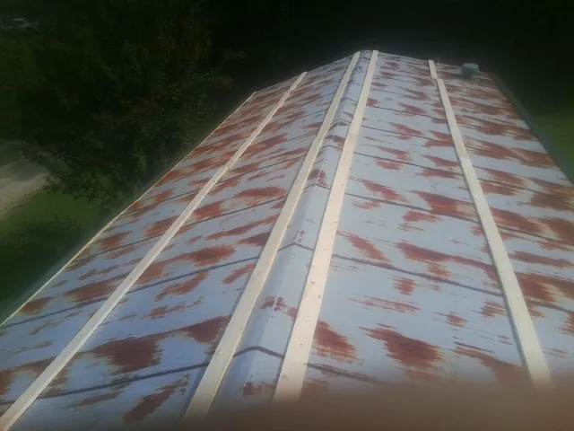 Rusted metal roof panels with new wood purlins before replacement — Storm Damage Roof Repair in Boulder Creek by Roofing Brothers